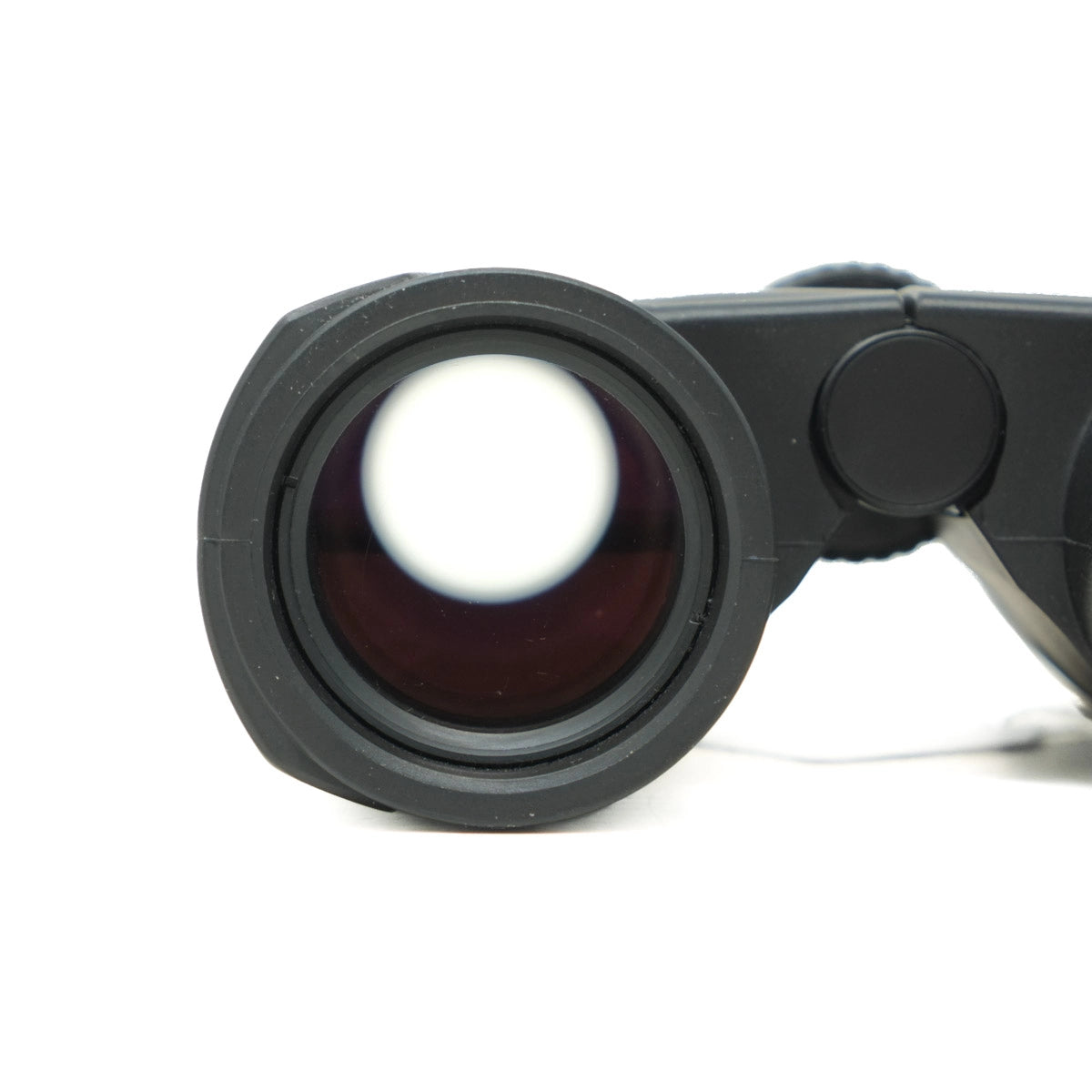 Close-up of a black binoculars lens on a white background