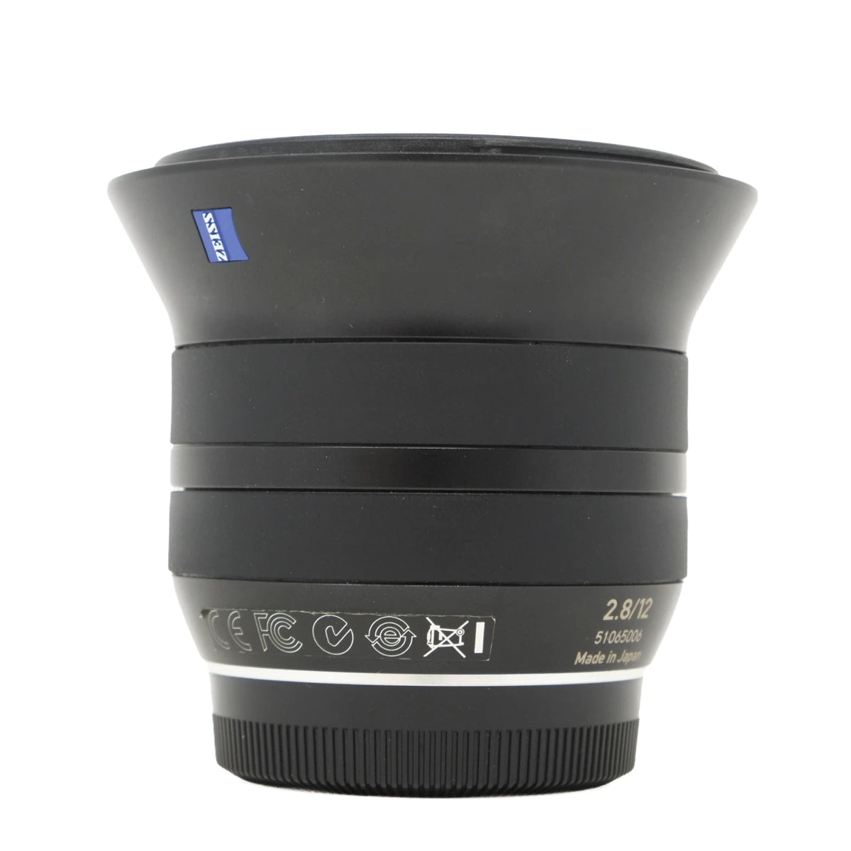 A black Zeiss Carl Zeiss T* 2.8/12 lens with a blue brand logo on the front, shown against a plain white background.
