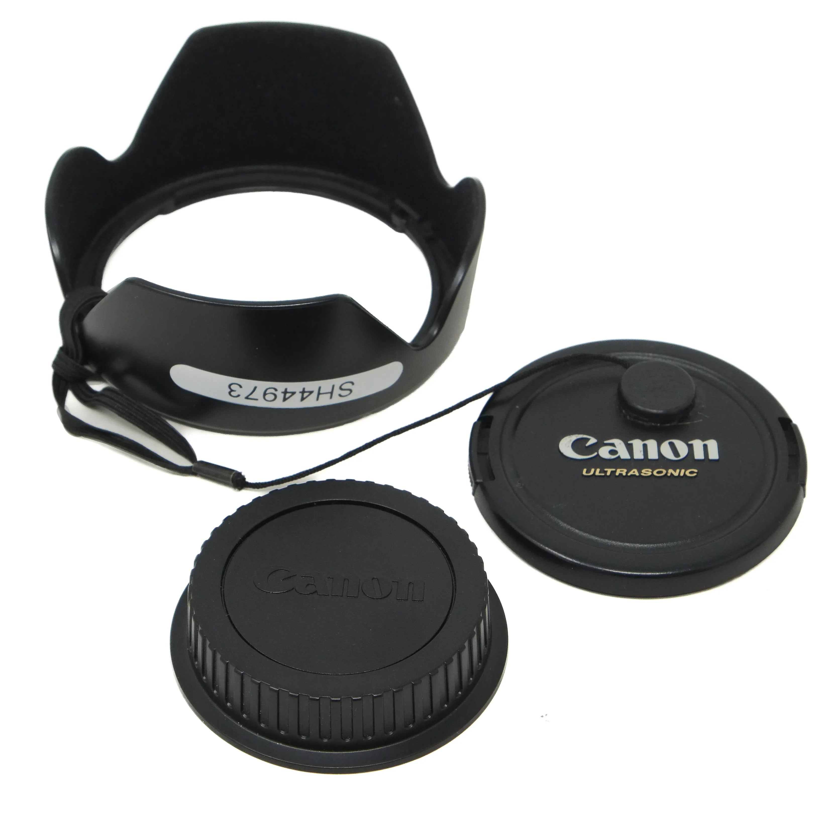 Canon lens cap, hood, and body cap on a white background