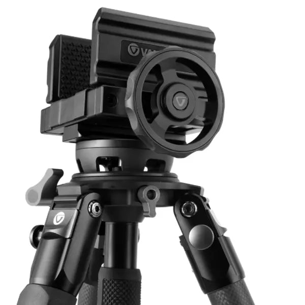 Black camera tripod with a smartphone mount on a white background