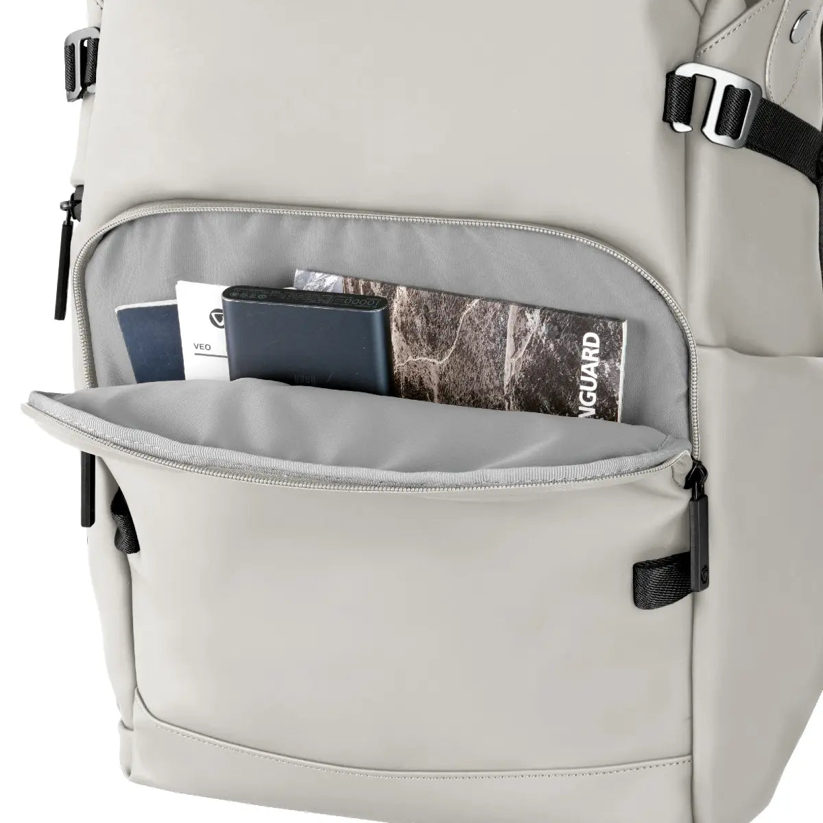 Gray backpack with open front pocket displaying items on a white background