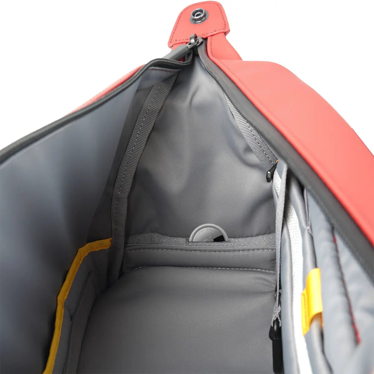 Close-up of a red and gray bag with a zipper, showing the interior.