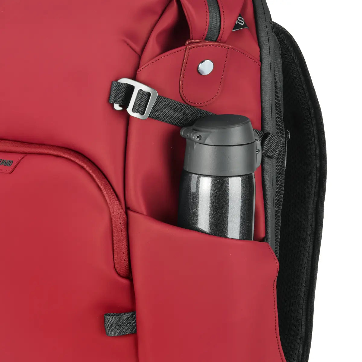 Red backpack with a black thermos inside a pocket
