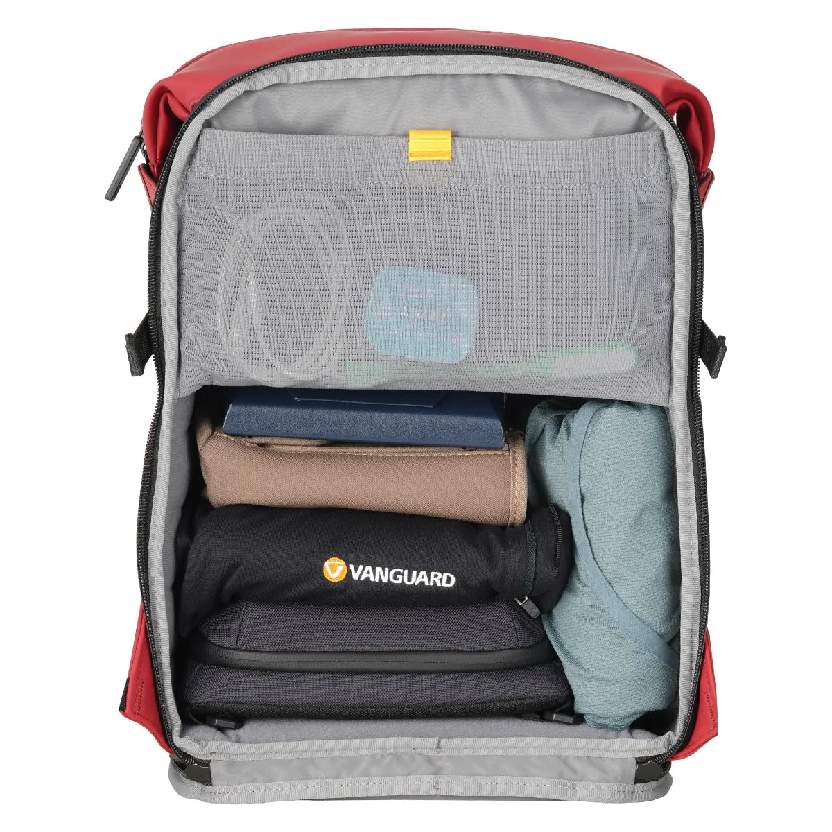 Open red backpack with clothes and a black bag labeled 'Vanguard' on a white background