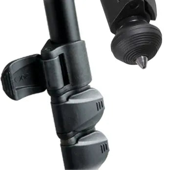 Close-up of a camera tripod with adjustable legs on a white background