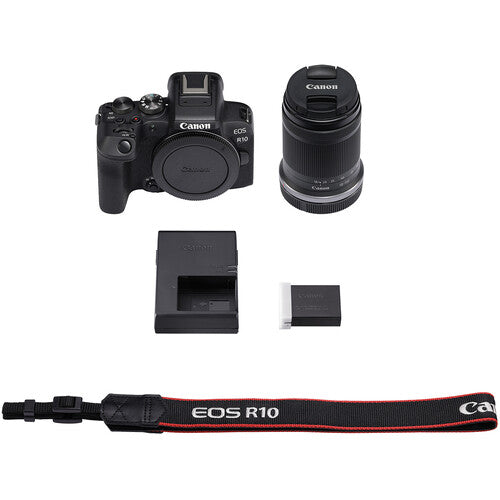 Canon EOS R10 Mirrorless Camera + RF-S 18-150mm F3.5-6.3 IS STM Lens Kit - Product Photo 7 - Fron view of the camera body, included lens, safety leash, battery charger and battery