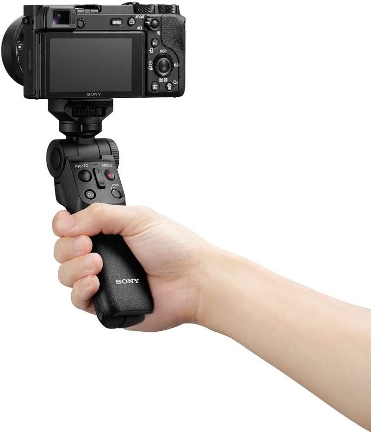 Sony Shooting Grip With Wireless Remote Commander GP-VPT2BT - Product Photo 3 - Photo of the grip in a persons hand with the camera attached. Showcasing the size and scale of the grip