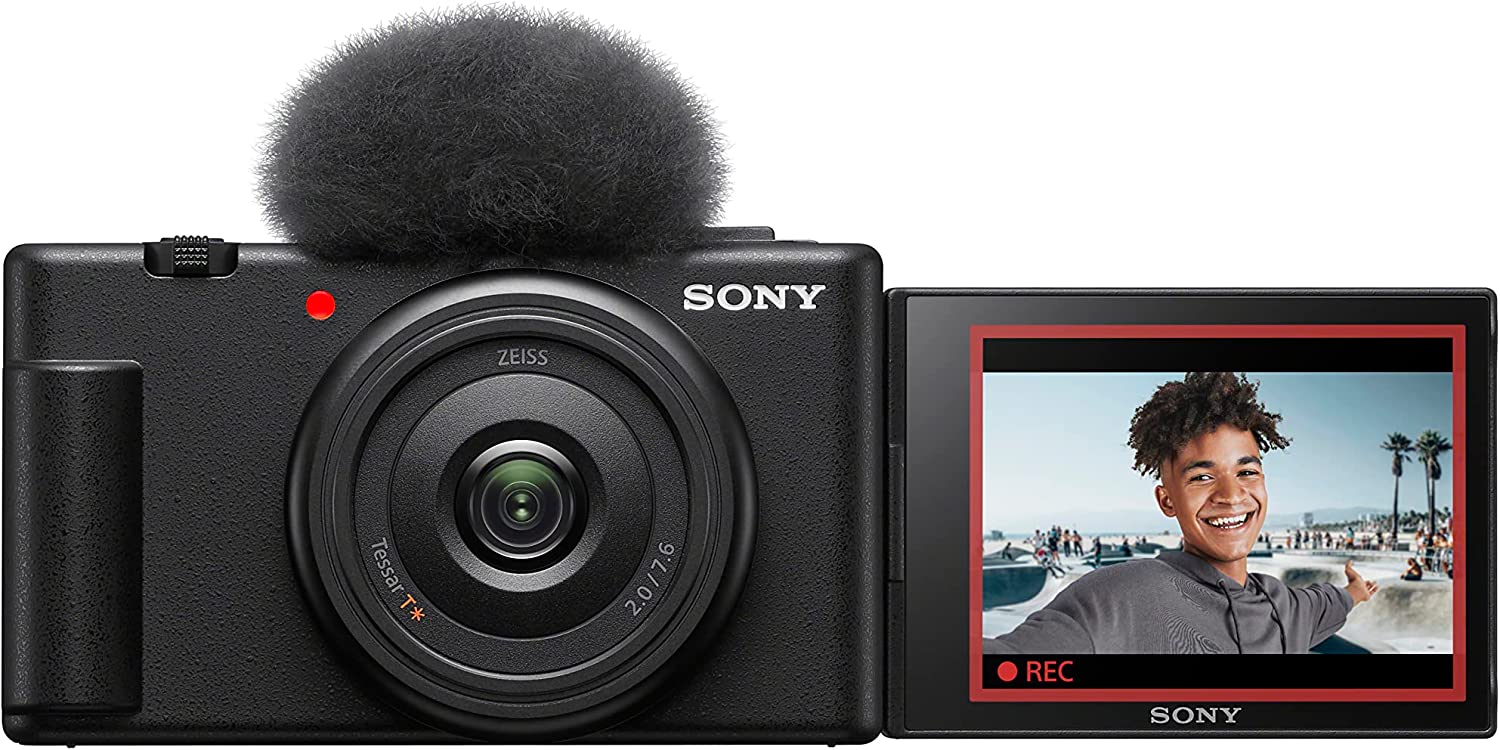 Sony ZV-1F Vlogging Camera - Product Photo 1 - Front view of the camera with the screen extended and microphone wind guard attached