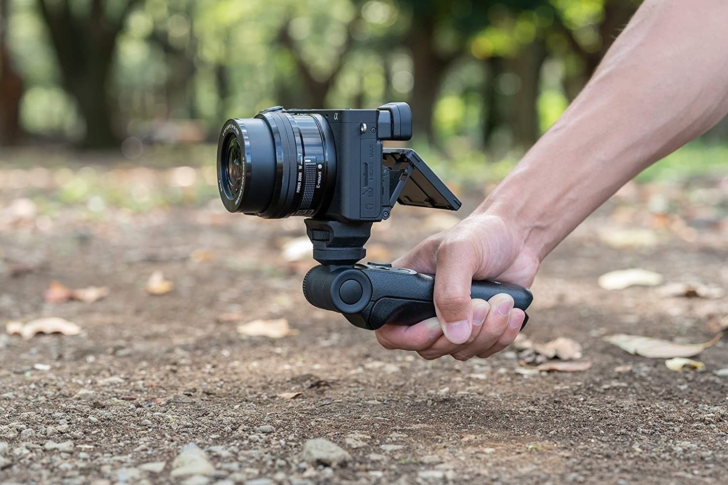 Sony Shooting Grip With Wireless Remote Commander GP-VPT2BT - Product Photo 5 - Another photo of the grip being used in real life with the camera attached and screen extended. Photo is set in the woods whilst being held by the photographer to show the size and scale of the grip